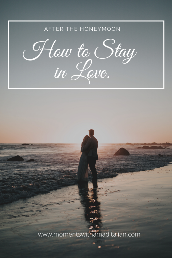 couple standing on beach at sunset