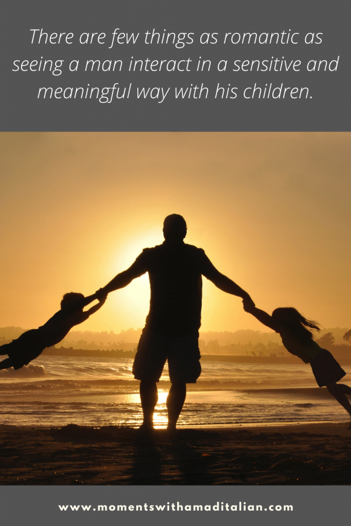 silhouette of a man swinging his two children around by the arms, on the beach at sunset