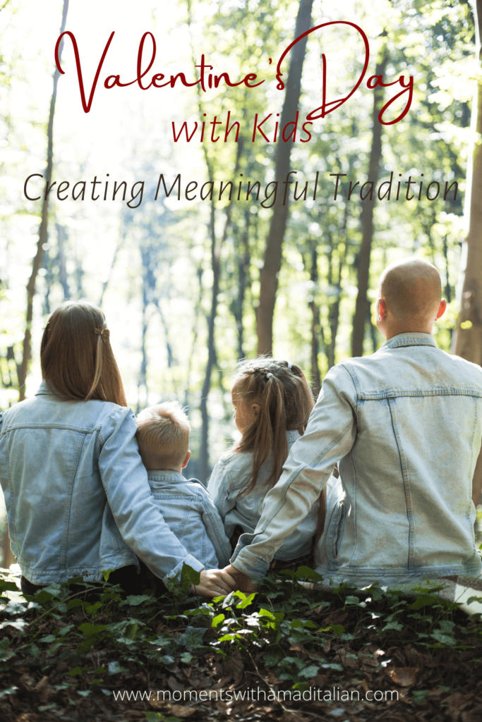 parents and two childred seated facing bush with back to camera, couple holding hands behind children seated between them.