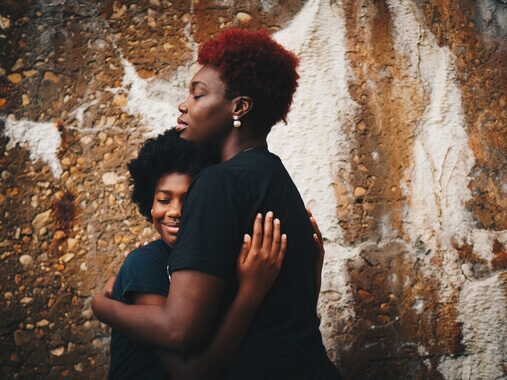 woman hugging teen daughter